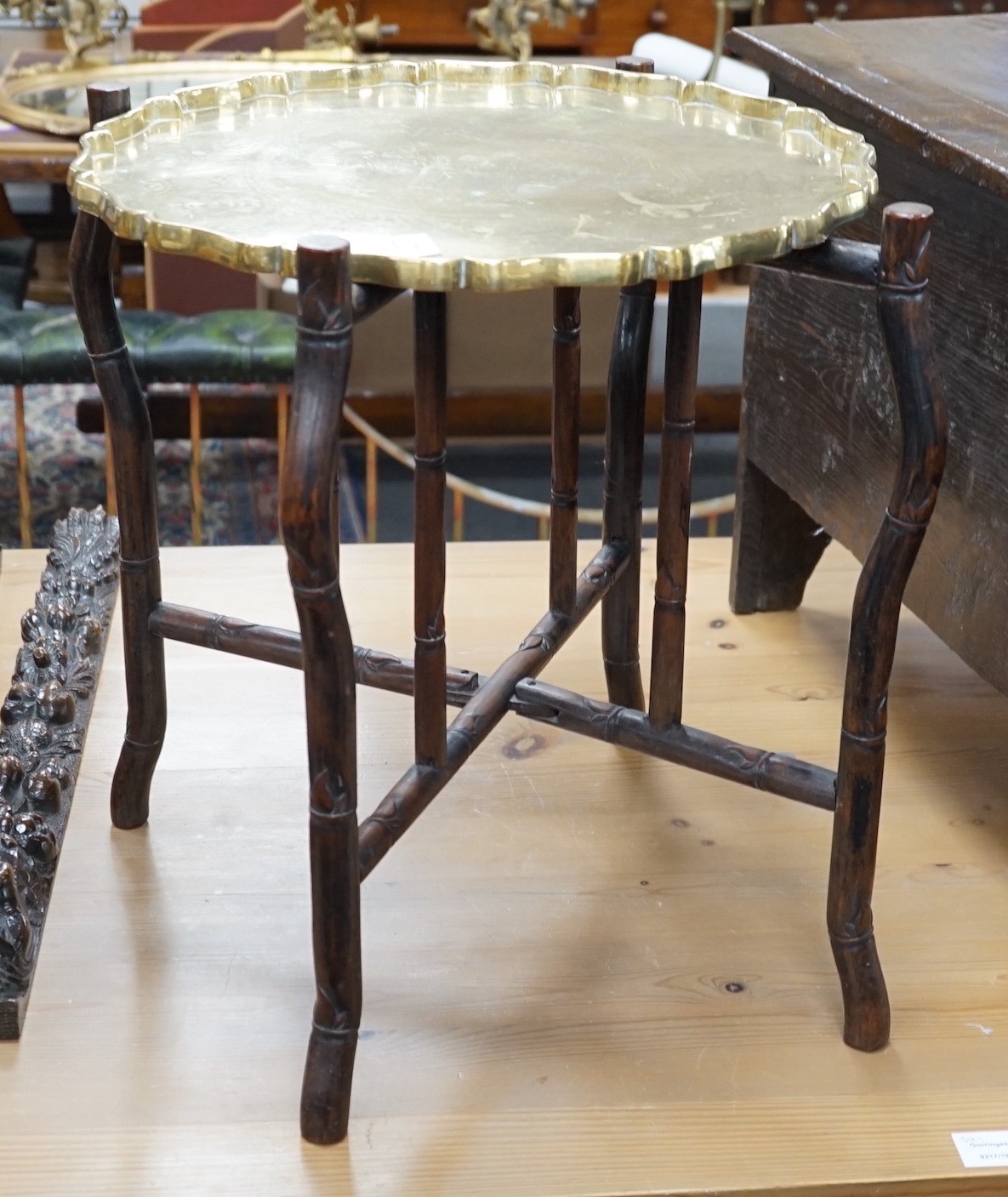 A Chinese brass tray topped hongmu folding occasional table, diameter 56cm *Please note the sale commences at 9am.